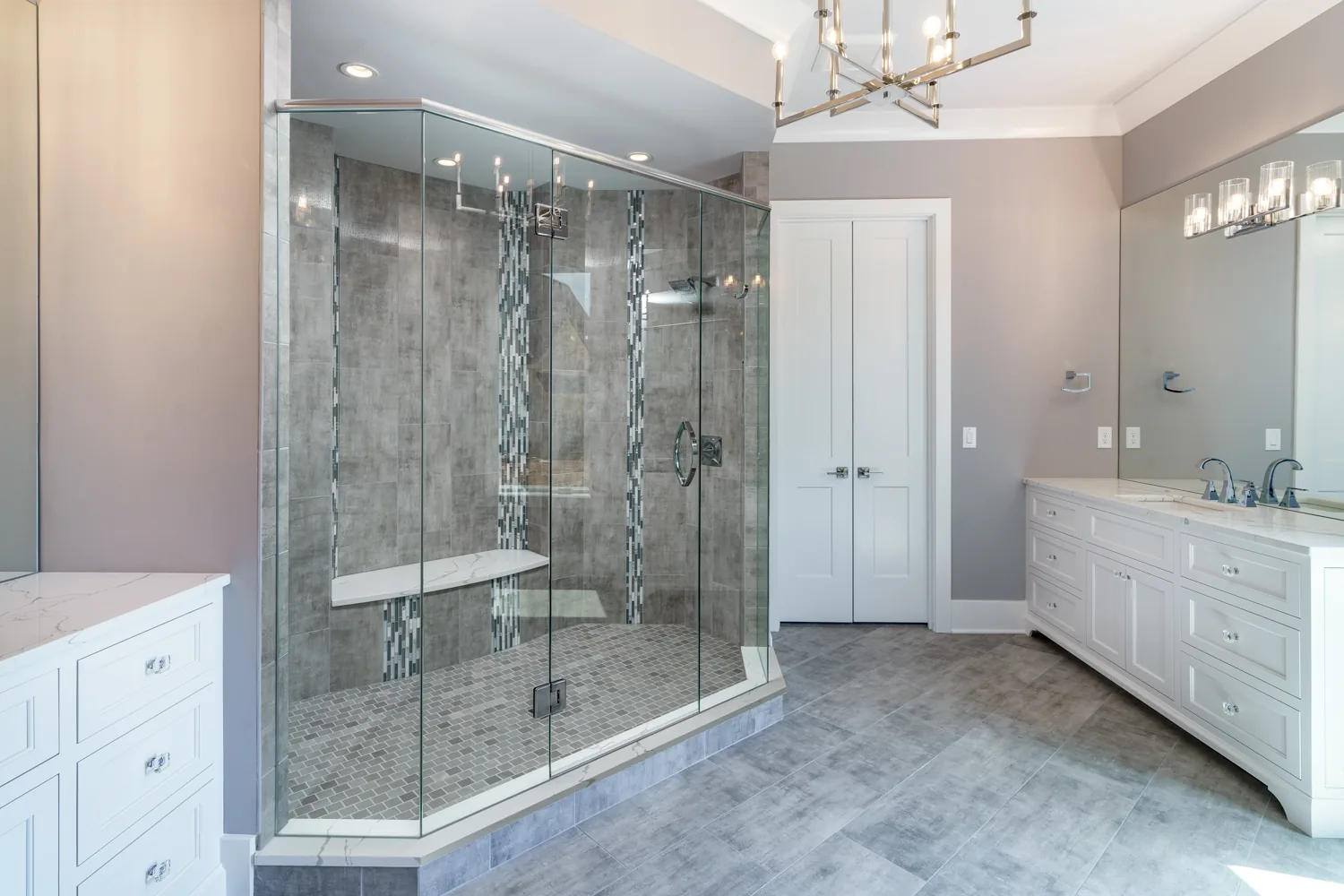 Light filled bathroom with freestanding tub and marble shower