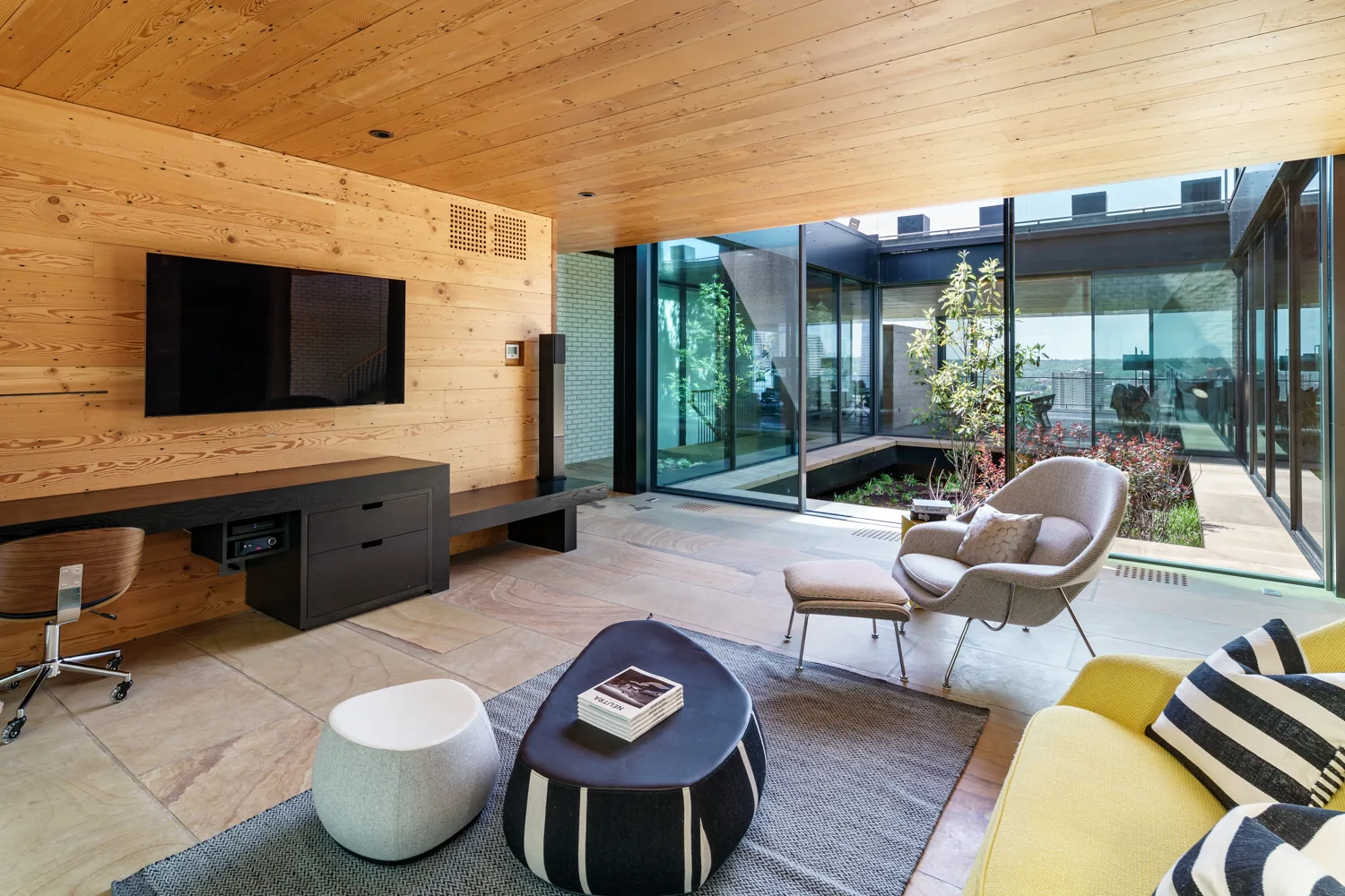 Contemporary living space with timber ceiling and sliding glass doors