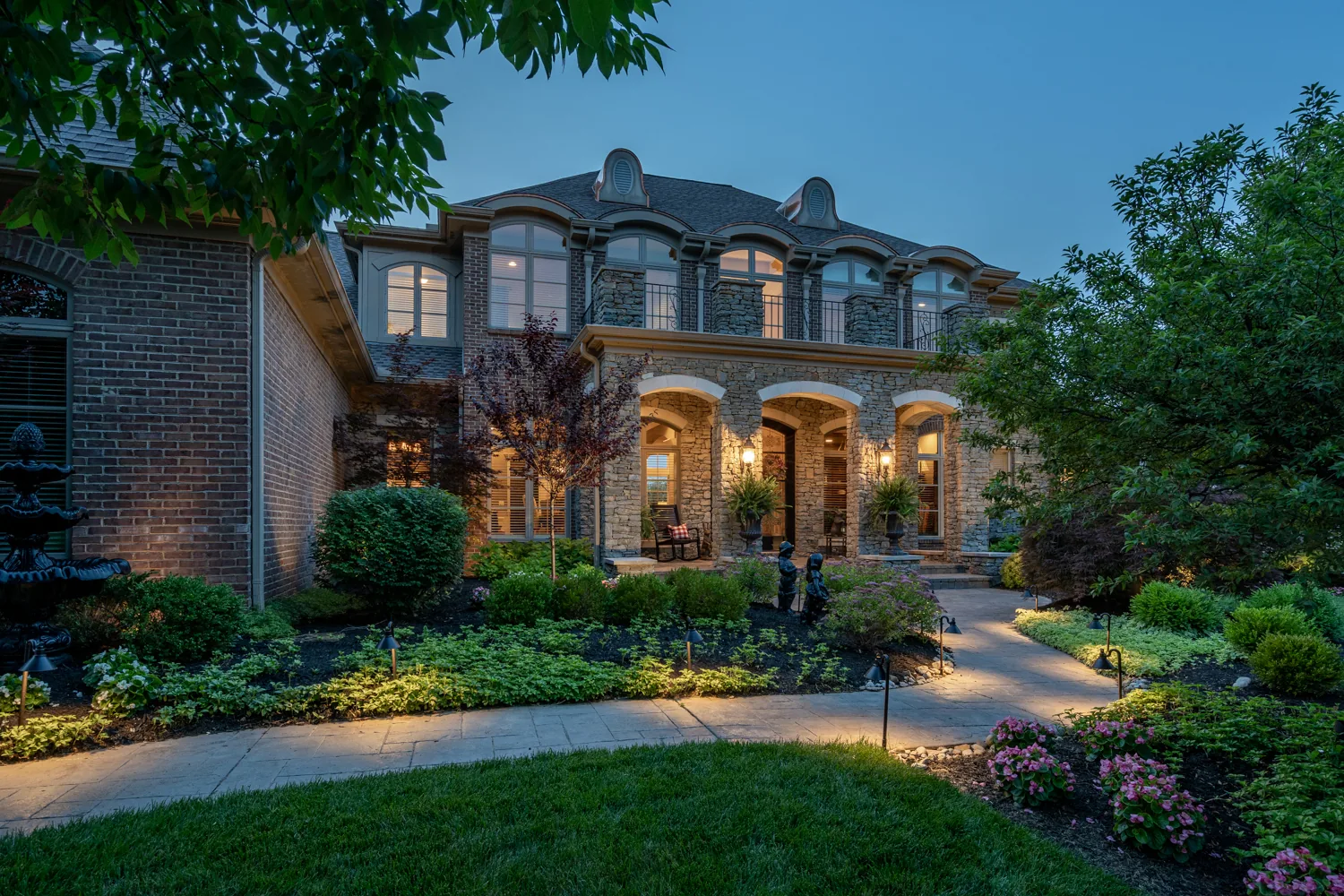 Brick home photographed at twilight with warm exterior lighting